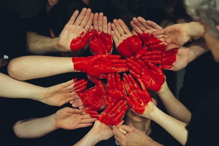 Red hands put together to form a heart