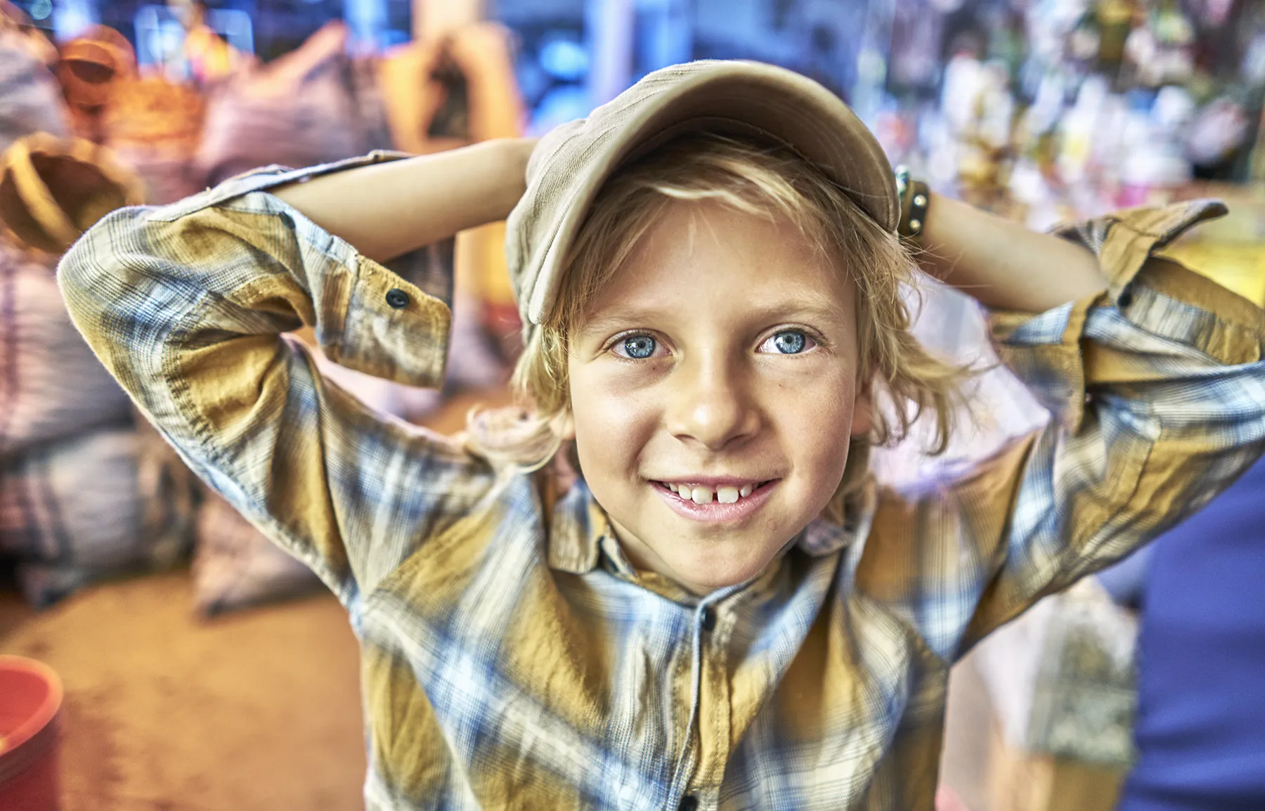 happy-child-exploring-a-vibrant-street-market-2025-04-04-21-46-52-utc Smiling young boy in a colorful setting, symbolizing childhood joy and the importance of family mental health services during Mental Health Awareness Month.